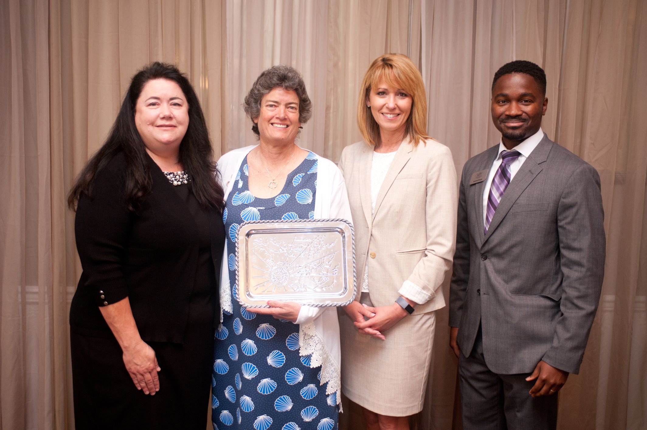 Kelly Phillips Cox with award