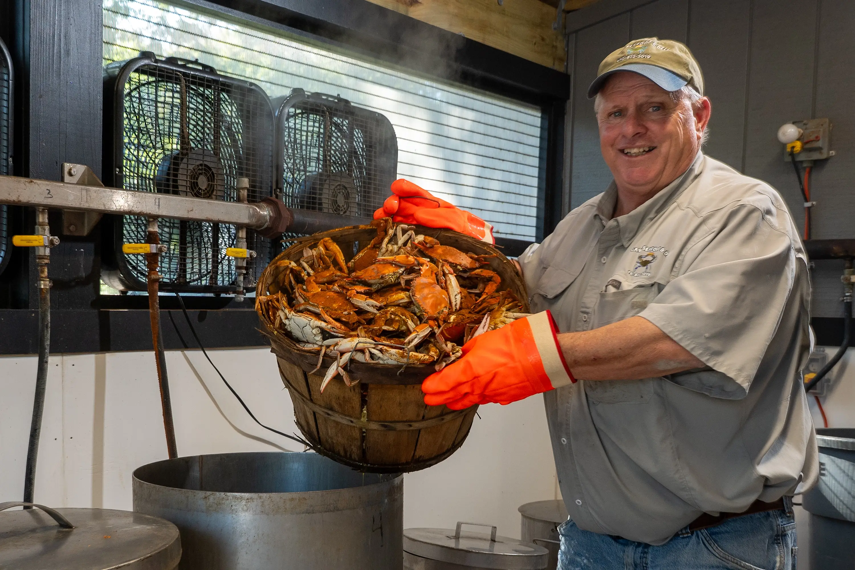 A man holding a pot of crabs