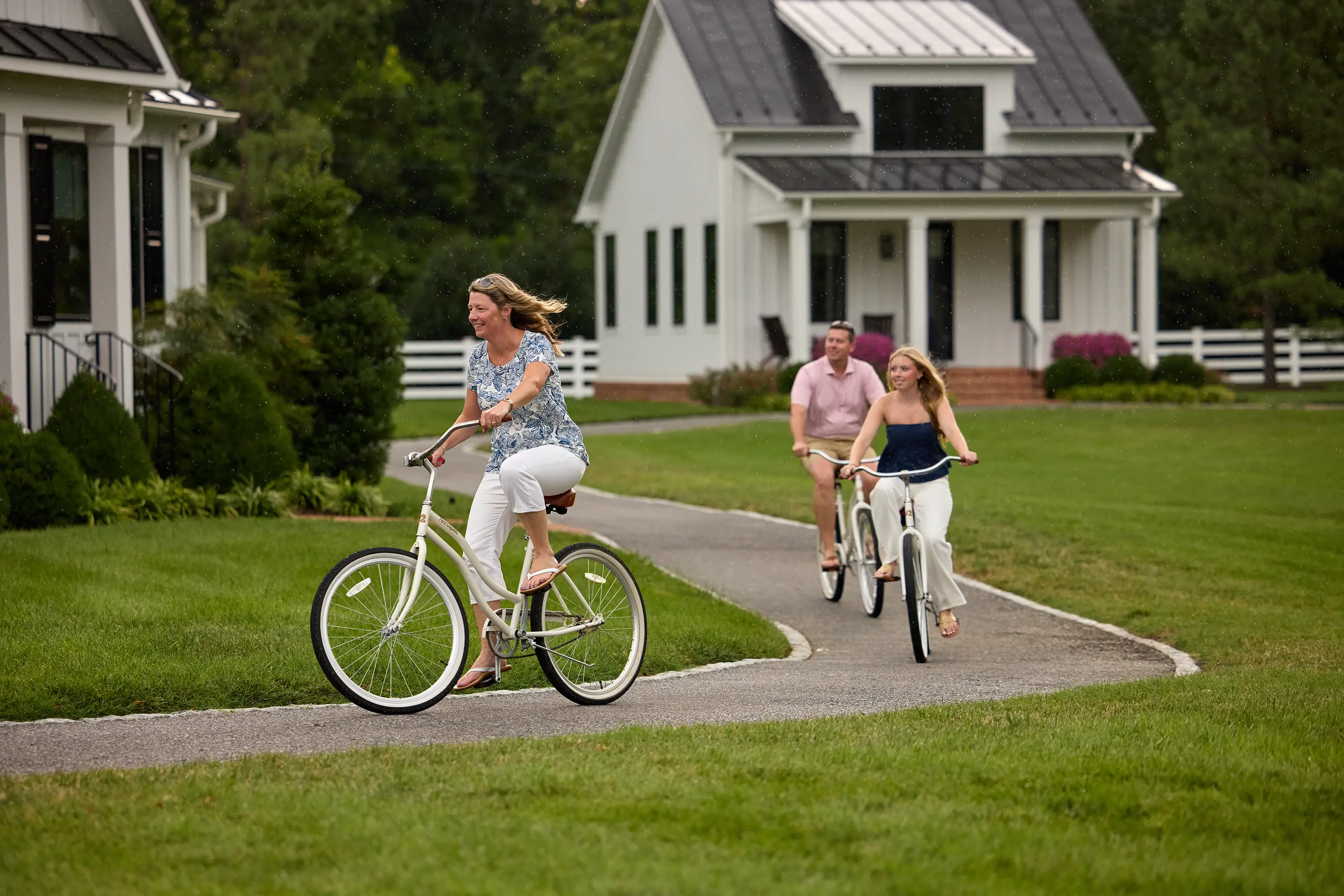A family bicycling on a sidewalk