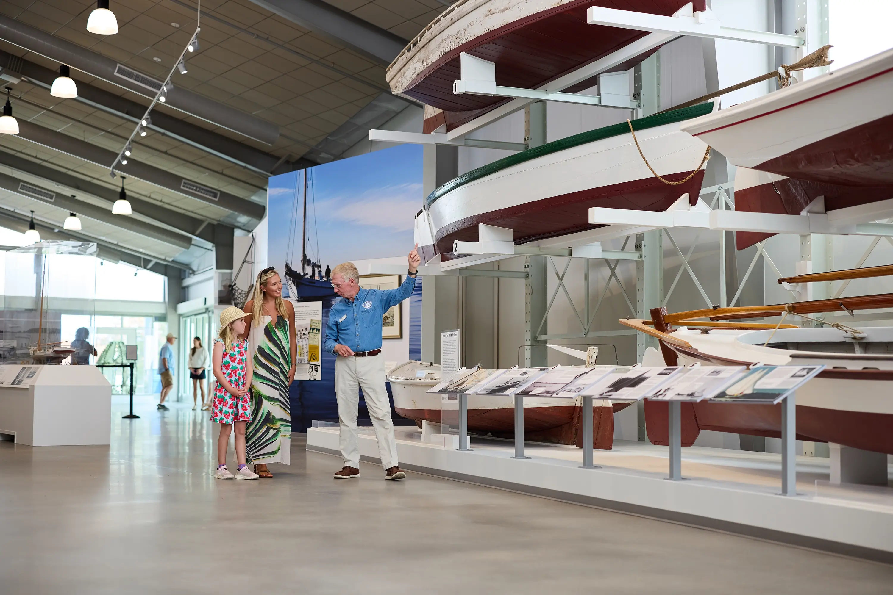 A mother and daughter viewing boats at a museum
