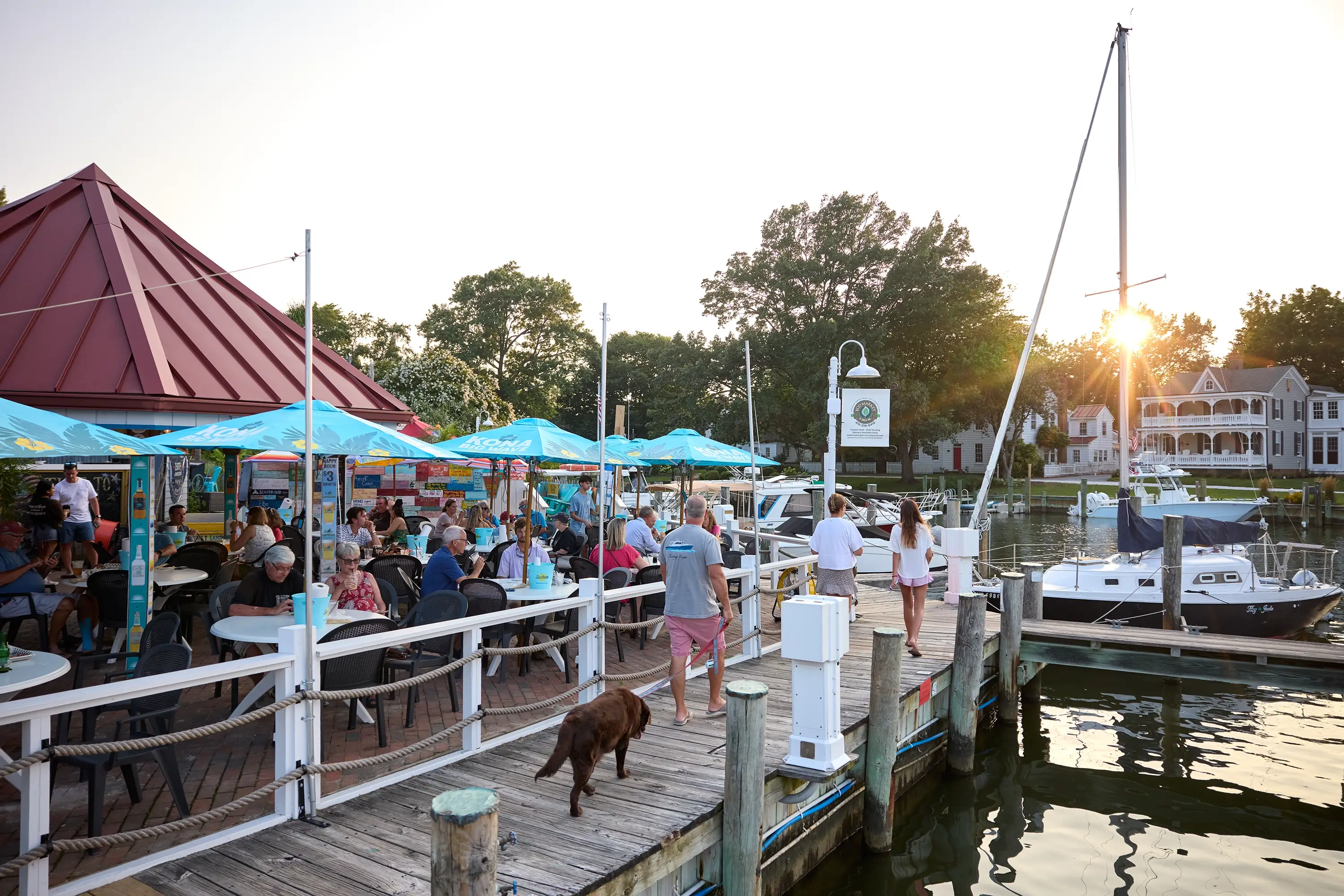 People eating at a restaurant by the marina